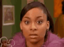 a close up of a woman 's face with a surprised expression .