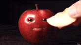 a person is taking a bite out of an apple with a face on it