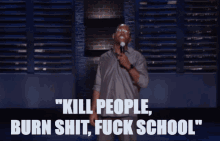 a man speaking into a microphone with the words kill people burn shit fuck school