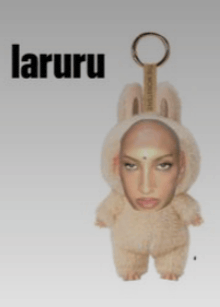 a stuffed animal with a woman 's face on it and the word laruru