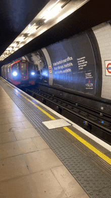 a train is pulling into a subway station with a sign on the wall that says ' a consultant in your office '