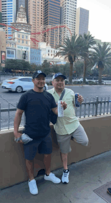 two men standing in front of a building that says irish pub on it