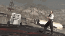 a man is standing on a roof in a video game while holding a gun .