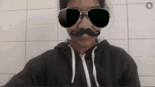 a man wearing sunglasses and a fake mustache