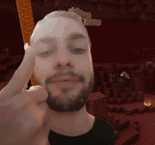 a man with a beard is giving the middle finger in front of a minecraft background