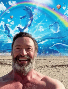 a man with a beard is smiling in front of a painting of dolphins
