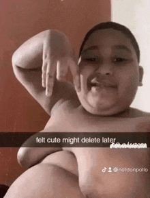 a young boy without a shirt is making a funny face and making a hand gesture .