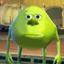 a close up of a green monster from monsters inc with a sad face