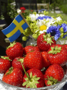 strawberries in a glass bowl with a swedish flag