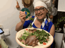 a woman in a chef 's hat holds a plate of food in front of a drum that says remo