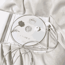 a cd with a flower on it and the words i need u on it