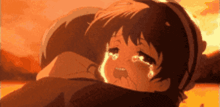 a girl is crying while being held by a man in a cartoon .