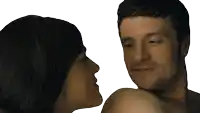 a man and a woman are looking at each other and the woman is kissing the man on the cheek