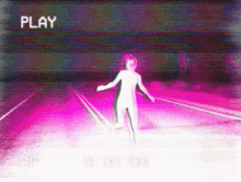 a video of a person standing on a road with the word play in the upper right corner