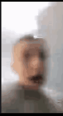 a blurry picture of a man 's face with a blurred background .