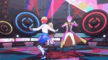 a group of anime characters are dancing on a stage in front of speakers