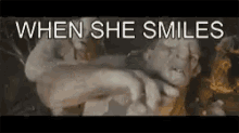 a close up of a person 's face with the words " when she smiles " above it