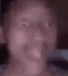 a close up of a person 's face with a blurred background .