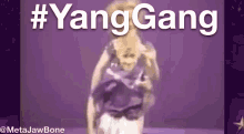 a purple background with the words #yanggang written in white