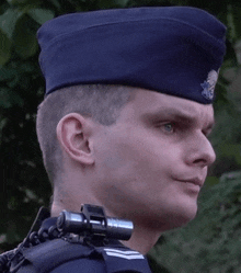 a man wearing a blue hat has a badge on his hat that says ' u.s. air force '