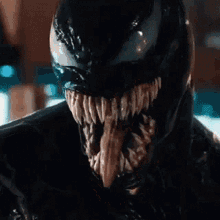 a close up of venom 's face with his tongue out .