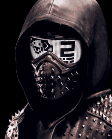 a man wearing a hooded jacket and a mask with spikes on it .