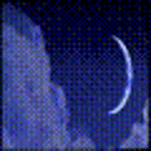 a crescent moon is visible in the night sky behind a cloud .