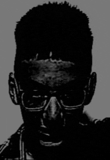 a silhouette of a man wearing glasses and headphones .