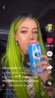 a woman with green hair drinking a can of bang energy