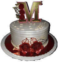 a white cake with red roses and a letter m on top