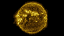 a close up of a yellow sun with a black background