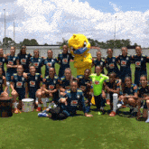 a group of female soccer players are posing for a photo with a mascot wearing a blue shirt that says brasil