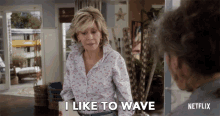 a woman says i like to wave in front of a netflix ad