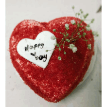 a heart shaped red velvet cake with a white heart that says happy day