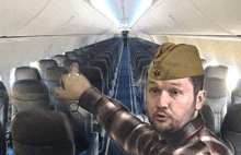 a man wearing a hat with a star on it stands in an empty plane