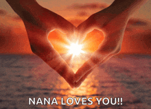 a woman making a heart shape with her hands with the words nana loves you below it