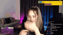 a woman is playing a video game on twitch