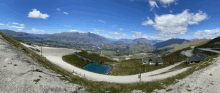 a view of a valley with mountains and a road