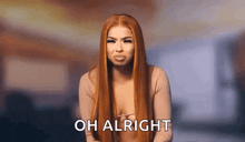 a woman with long red hair is making a funny face and saying oh alright .