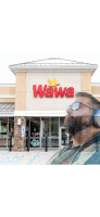 a man wearing headphones stands in front of a wawa