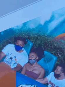 a man wearing a polo shirt is riding a roller coaster with two other people