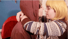 a man and a woman are hugging and kissing
