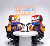 a couple of people sitting at a table with a sign that says bam updates africa