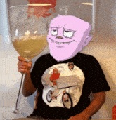 a man wearing a t-shirt with a picture of et on it holds a large wine glass