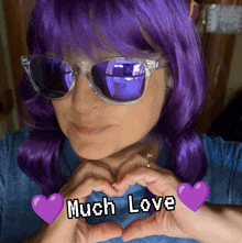 a woman with purple hair making a heart with her hands and the words much love