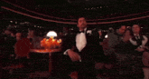a man in a tuxedo is talking on a cellphone