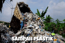 a truck dumping a pile of garbage with the words sampah plastik on the bottom