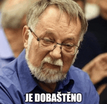 a man with glasses and a beard has je dobastino written below him