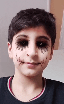 a young boy with his face painted to look like a joker