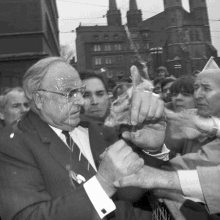 a man in a suit and tie is being sprayed with powder